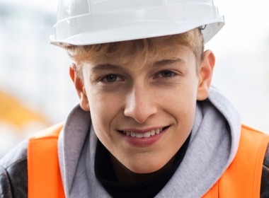 Person wearing safety hat and a hi vis jacket