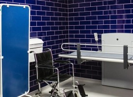Changing toilet with blue tiles