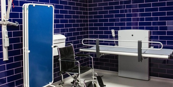 Changing toilet with blue tiles