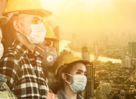 People wearing face masks and safety hats